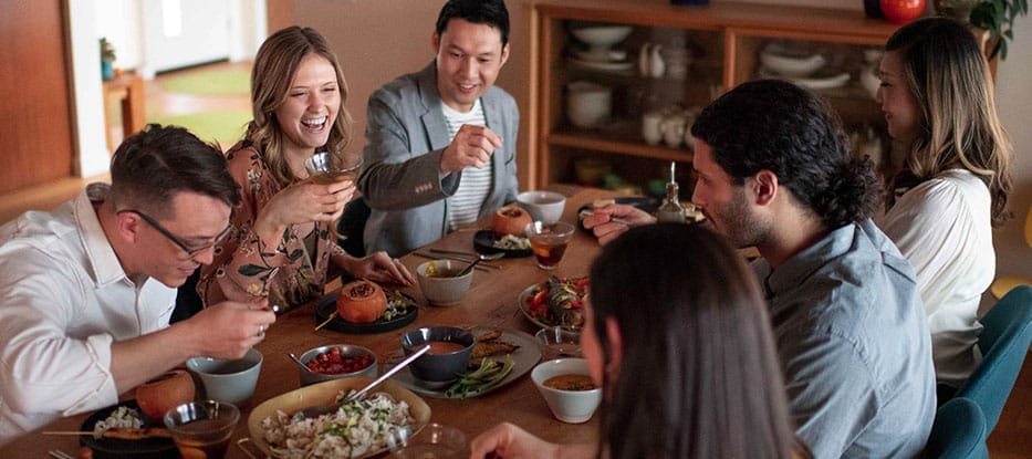 adults eating around a dinner table